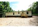 Rear view of the manufactured home, showcasing the back deck and AC unit at 2574 Orchard Rd, Smyrna, SC 29743