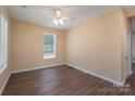 Simple spare bedroom with laminate wood flooring and a ceiling fan at 1021 Wall St, Statesville, NC 28677