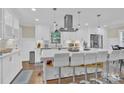 Modern kitchen island with seating and white cabinets at 6639 Ronda Ave, Charlotte, NC 28211