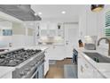 Modern kitchen with stainless steel appliances and white cabinets at 6639 Ronda Ave, Charlotte, NC 28211
