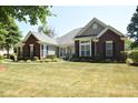 Brick and siding ranch home with landscaped yard at 6929 Plough Dr, Charlotte, NC 28227