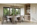 Elegant dining room with wood cabinets and a large chandelier at 626 Concord Rd, Davidson, NC 28036