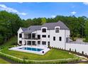 Stunning pool and backyard area of the house with beautiful landscaping at 18304 Rosapenny Rd, Charlotte, NC 28278