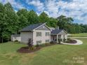 Two story house with stone accents and a detached shed at 213 Press Sweezy Rd, Kings Mountain, NC 28086