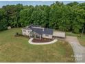 Stunning aerial view of a house nestled in a wooded setting with a spacious yard at 213 Press Sweezy Rd, Kings Mountain, NC 28086