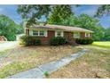 Brick ranch house with a spacious yard and trees at 2501 Twin Ave, Gastonia, NC 28052