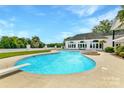 Inviting kidney-shaped pool with diving board and fire pit at 3245 Jackson Rd, Mooresville, NC 28115