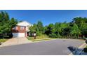 Two-story brick home with attached garage and wooded backyard at 9424 Eagle Feathers Dr, Charlotte, NC 28214