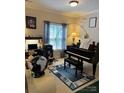 Bright music room featuring a grand piano, comfortable seating, and natural light at 1376 21St Ne Ave, Hickory, NC 28601
