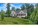 Gray house with white trim and a large grassy yard at 6515 Havencrest Dr, Denver, NC 28037