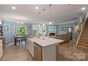 Open concept kitchen with island and living room view at 116 Hornbeam Ln, Mooresville, NC 28117