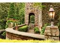 Landscaped walkway detail with stonework, greenery, and a light fixture at 1008 Medinah Ct, Waxhaw, NC 28173