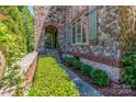 Landscaped walkway leading to a stone and brick home entrance at 1008 Medinah Ct, Waxhaw, NC 28173