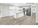 Modern kitchen with island, stainless steel appliances, and white cabinetry at 335 Maplestead St # 1112, Lancaster, SC 29720