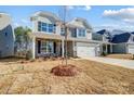 Two-story house with gray siding, stone accents, and a white door at 5312 Verona Rd # 74, Charlotte, NC 28213