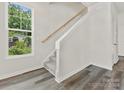 Modern staircase with wood railing and carpeted steps at 1008 Ribbon Ln, Charlotte, NC 28205