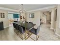 Bright dining room featuring a large table with seating for six and hardwood floors at 4141 Deerfield Nw Dr, Concord, NC 28027