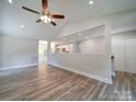 Open concept living room with kitchen view and hardwood floors at 526 Manchester Rd, Mount Gilead, NC 27306