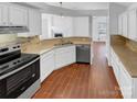 Kitchen with granite countertops and wood-look floors at 6614 Flat Creek Dr, Charlotte, NC 28277