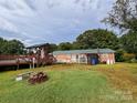 Large backyard with deck, above ground pool, and firepit at 1470 River Hills Ct, Taylorsville, NC 28681