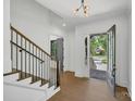 Bright entryway with hardwood floors, modern staircase, and view to backyard at 1106 Anniston Pl # 51, Indian Trail, NC 28079