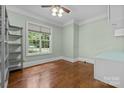 Bright office with hardwood floors, built-in shelving and large window at 7230 Timber Ridge Dr, Mint Hill, NC 28227