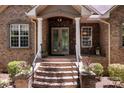 Brick front entrance with double doors and stone accents at 7230 Timber Ridge Dr, Mint Hill, NC 28227