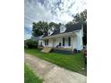 White house with front porch, side yard and driveway at 505 Cemetary St, Salisbury, NC 28144