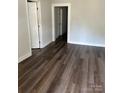 Living room with dark laminate floors and neutral walls at 505 Cemetary St, Salisbury, NC 28144
