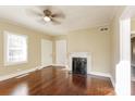 Living room with hardwood floors, fireplace and ceiling fan at 1912 Hemlock Ave, Gastonia, NC 28054