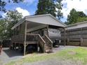 Covered RV parking with a deck and stairs at 111 Hollywood Trl, Mount Gilead, NC 27306