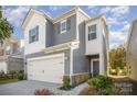 Two-story home with gray siding, white accents, and a two-car garage at 168 Ravensara Ave, Fort Mill, SC 29715