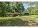 Ranch home surrounded by lush green trees and lawn at 7714 Old Waxhaw Monroe Rd, Waxhaw, NC 28173