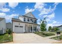 Two-story white house with gray roof, front porch, and attached garage at 29060 Low Country Ln, Lancaster, SC 29720