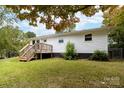 Side view of the white ranch home showcasing the deck and backyard access at 115 E Georgia Ave, Bessemer City, NC 28016