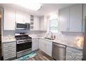 Updated kitchen with stainless steel appliances and light gray cabinets at 416 Witten Ln, Gastonia, NC 28052