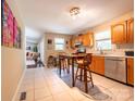 Kitchen with oak cabinets, tile floors, and breakfast bar at 3711 Davis Dr, Charlotte, NC 28270