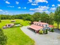Aerial view of the property showcasing the barn, pool, and outbuildings at 1441 Sulphur Springs Rd, Shelby, NC 28152