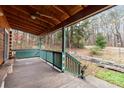 Spacious back porch with wooden swing and scenic wooded views at 902 Coldwater Ct, Concord, NC 28025