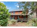 Log home with wrap-around porch, offering a charming and peaceful atmosphere at 902 Coldwater Ct, Concord, NC 28025