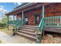 Inviting front porch with wooden railings and rocking chairs, perfect for relaxing at 902 Coldwater Ct, Concord, NC 28025