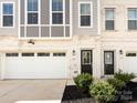 Charming townhome with black front door and white garage at 2642 Roseglen Ln, Indian Land, SC 29707