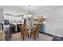 Bright kitchen with stainless steel appliances and adjacent dining area with seating for four at 12119 Brooklyn Ave, Charlotte, NC 28204