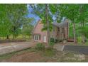 Brick home with a deck, patio, and pond view at 15610 Youngblood Rd, Charlotte, NC 28278