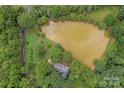 Aerial view of a house and private pond at 15610 Youngblood Rd, Charlotte, NC 28278