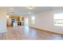 Open living room and kitchen with hardwood floors and modern kitchen at 1813 Augustine St, Monroe, NC 28112