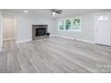Living room with wood-look flooring, fireplace, and ceiling fan at 5625 Highway 601 Hwy, Salisbury, NC 28147