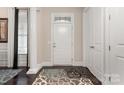 Bright entryway with hardwood floors, columns and a rug at 15814 Vale Ridge Dr, Charlotte, NC 28278