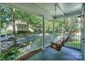 Front porch with hanging swing, overlooking a tree-lined street at 13950 Cinnabar Pl, Huntersville, NC 28078