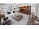 Open living room and kitchen with hardwood floors at 8819 Richardson King Rd, Waxhaw, NC 28173
